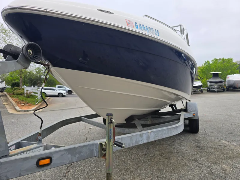 Slide: The Image of 2009 Yamaha Boats AR230 HO on trailer, parked outdoors, showcasing sleek hull design. - 8