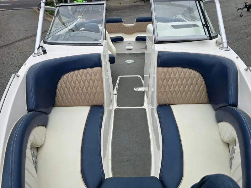Slide: The Image of 2009 Yamaha Boats AR230 HO interior with blue and beige seating, open bow design. - 9
