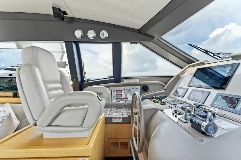 Slide: The Image of Luxurious helm of 2013 Ferretti Yachts 620 with modern controls and plush seating. - 20