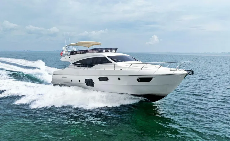 The Image of 2013 Ferretti Yachts 620 cruising on open water under a clear sky. - 1