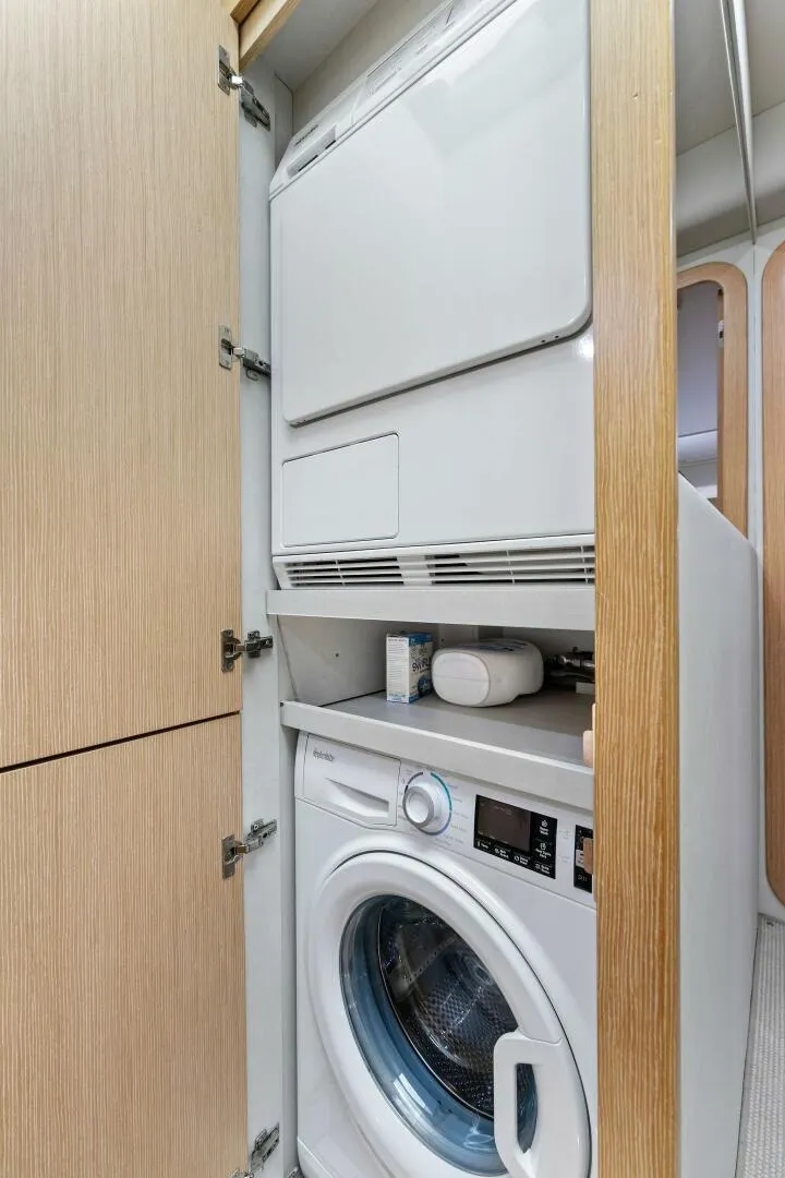 Slide: The Image of Laundry area inside 2013 Ferretti Yachts 620, featuring stacked washer and dryer. - 14