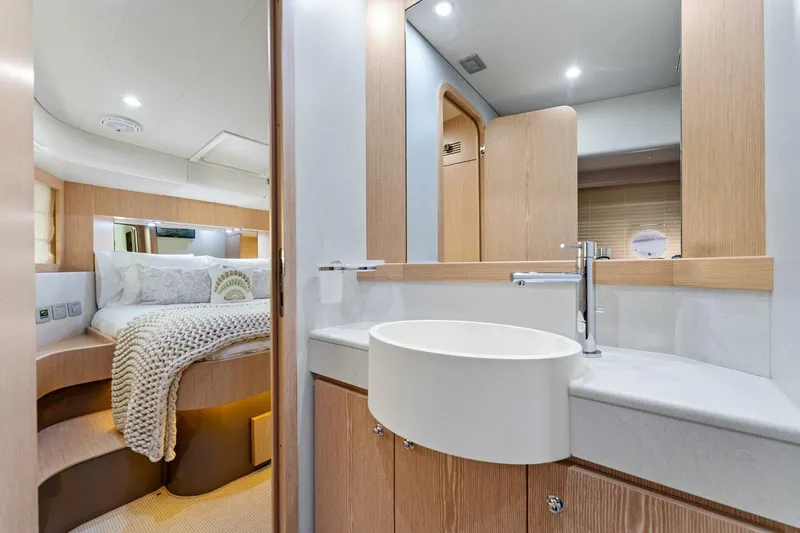 Slide: The Image of Luxurious Ferretti Yachts 620 interior, featuring a modern bathroom and cozy bedroom, 2013 model. - 34