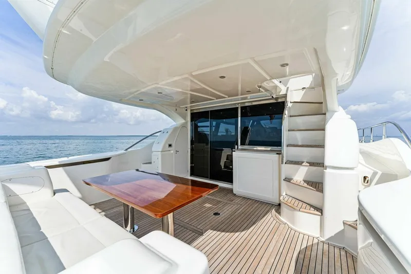 Slide: The Image of Luxurious 2013 Ferretti Yachts 620 deck with seating, table, and ocean view. - 42