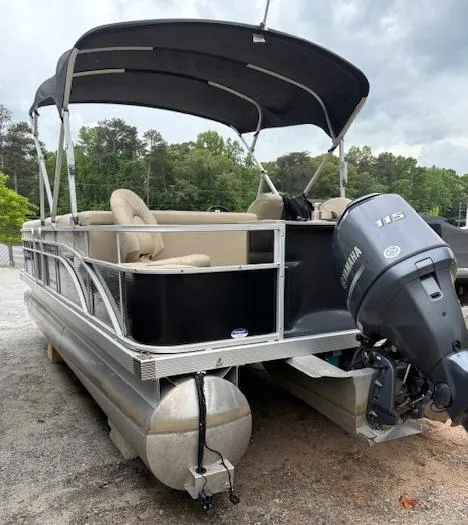 Slide: The Image of 2014 Bennington 22 SSX pontoon boat with Yamaha 115 engine, parked on gravel. - 13