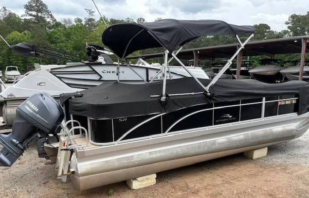 Slide: The Image of 2014 Bennington 22 SSX pontoon boat with black canopy and Yamaha outboard motor. - 14