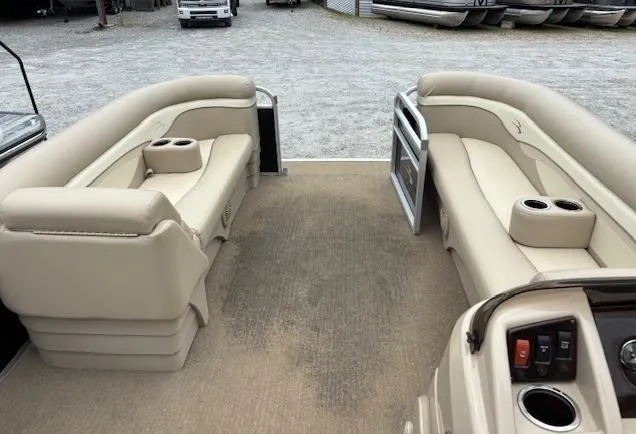 Slide: The Image of 2014 Bennington 22 SSX pontoon boat interior with beige seating and cup holders. - 2