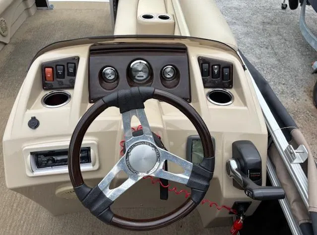Slide: The Image of 2014 Bennington 22 SSX boat dashboard with steering wheel and control panel. - 5