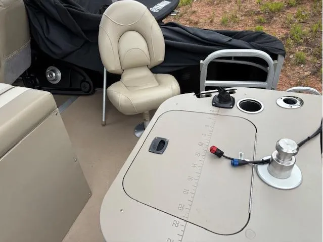 Slide: The Image of 2014 Bennington 22 SSX boat interior with beige seating and fishing station. - 7