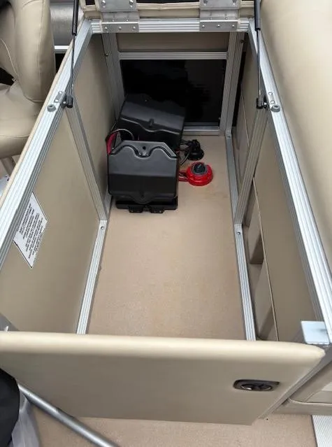 Slide: The Image of 2014 Bennington 22 SSX storage compartment with battery and wiring. - 8