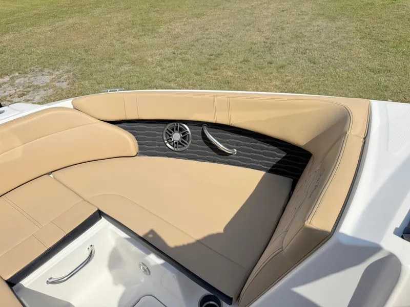 Slide: The Image of 2022 Sea Ray SPX 230 OB boat interior with tan seating and speaker detail. - 10