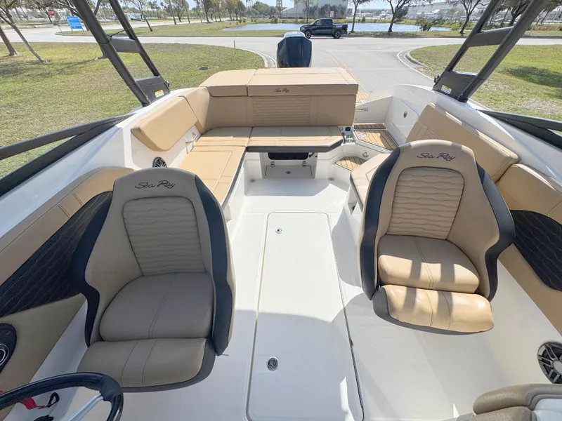 Slide: The Image of 2022 Sea Ray SPX 230 OB boat interior with tan seating and spacious layout. - 12