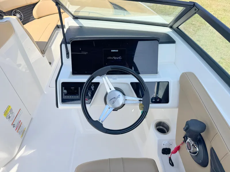 Slide: The Image of 2022 Sea Ray SPX 230 OB boat cockpit with steering wheel and control panel. - 15