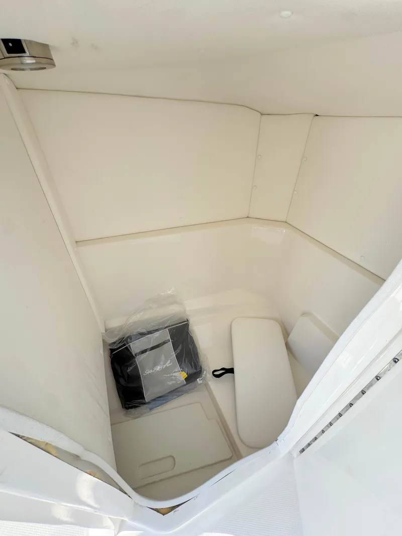 Slide: The Image of 2022 Sea Ray SPX 230 OB interior cabin with seating and storage. - 20