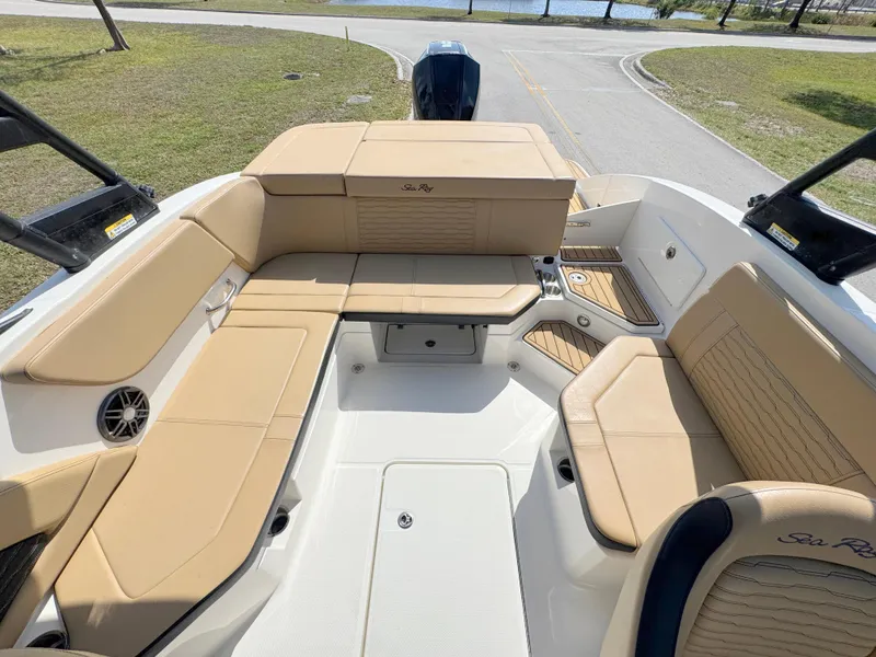 Slide: The Image of 2022 Sea Ray SPX 230 OB boat interior with tan seating and spacious layout. - 21