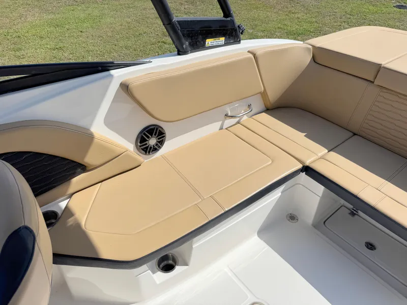 Slide: The Image of 2022 Sea Ray SPX 230 OB boat interior with beige seating and speaker. - 22
