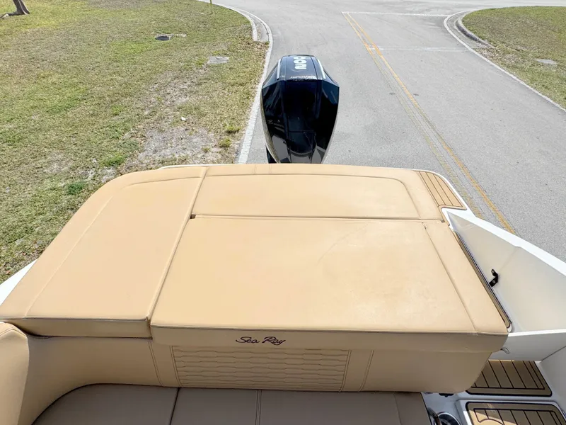 Slide: The Image of 2022 Sea Ray SPX 230 OB boat with tan seating and outboard motor. - 26