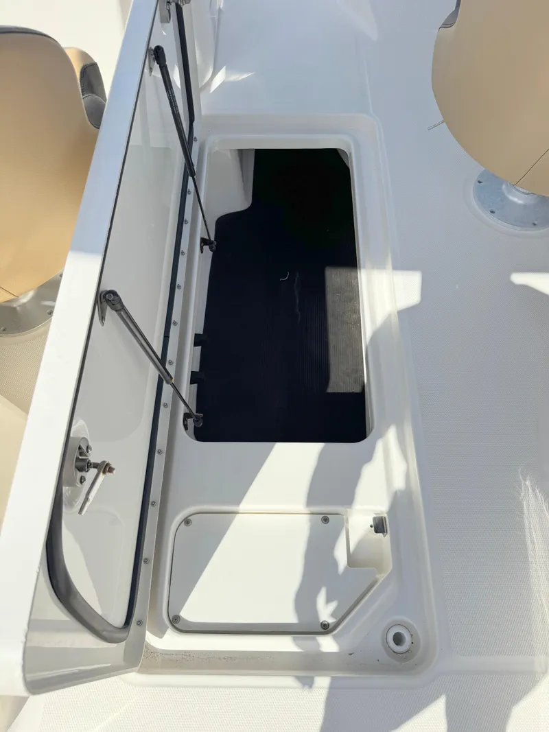 Slide: The Image of 2022 Sea Ray SPX 230 OB boat storage compartment open on deck. - 29