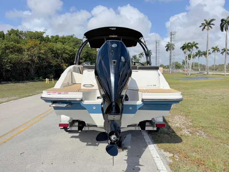 Slide: The Image of 2022 Sea Ray SPX 230 OB boat on a road, rear view, with outboard motor. - 3