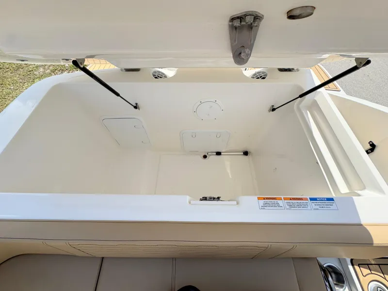 Slide: The Image of Open storage compartment of 2022 Sea Ray SPX 230 OB boat, showcasing spacious interior. - 31