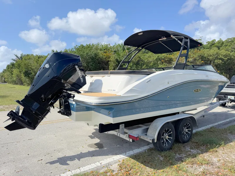 Slide: The Image of 2022 Sea Ray SPX 230 OB boat on trailer, parked outdoors under a clear sky. - 4