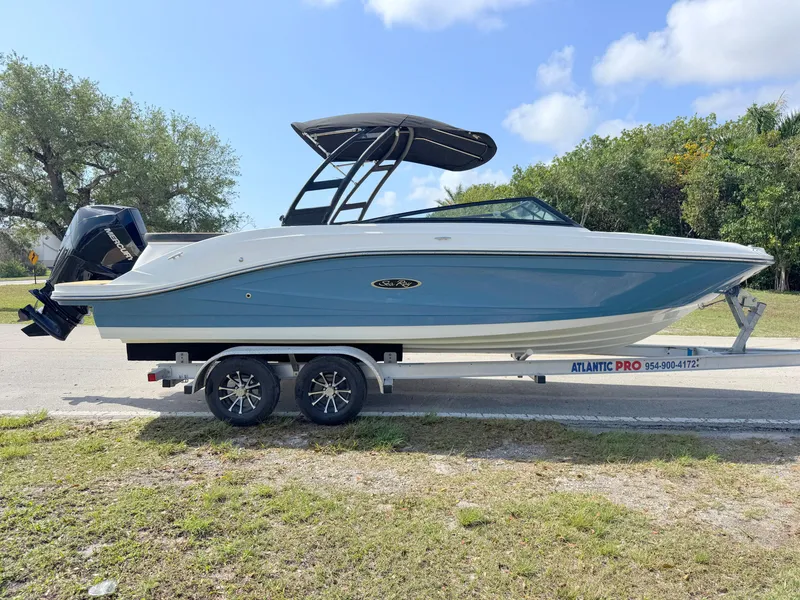 Slide: The Image of 2022 Sea Ray SPX 230 OB boat on trailer, parked outdoors under a clear sky. - 5