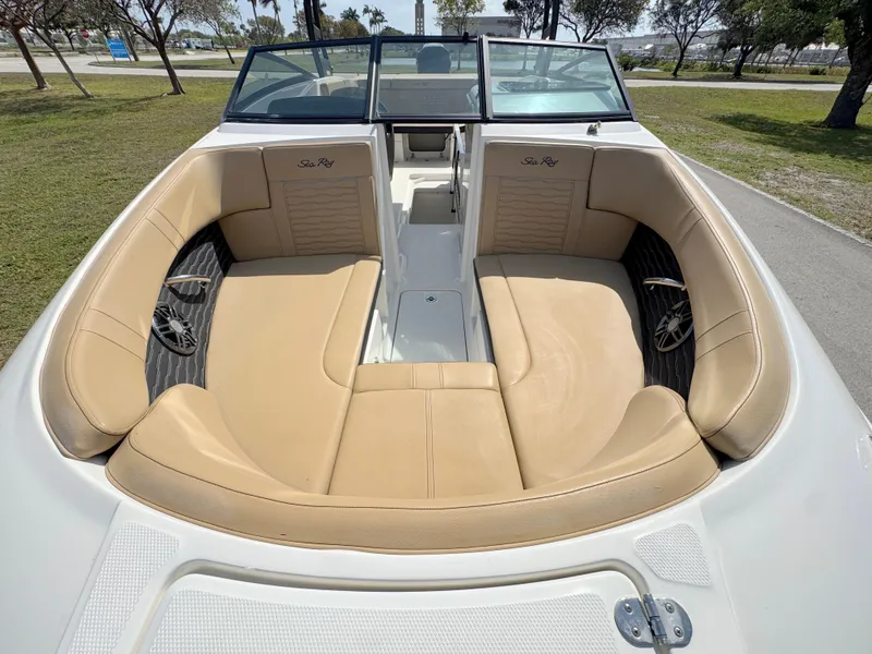 Slide: The Image of 2022 Sea Ray SPX 230 OB boat interior with tan leather seating and open bow design. - 7