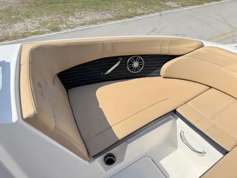 Slide: The Image of 2022 Sea Ray SPX 230 OB boat with tan seating and speaker detail. - 9