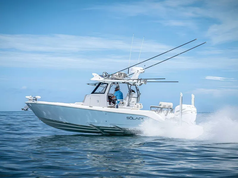 Slide: The Image of 2026 Solace 30 CS boat cruising on open water under clear blue skies. - 1