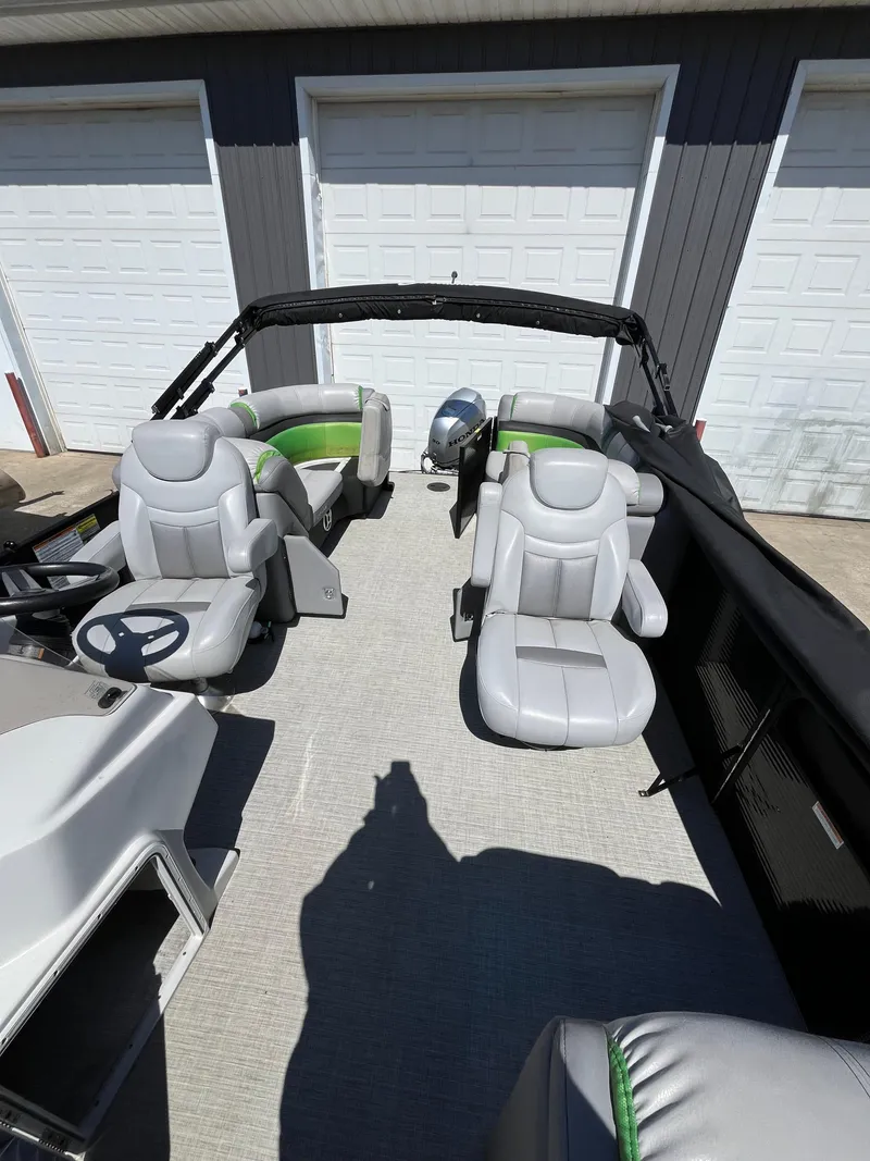 Slide: The Image of 2018 Sweetwater 2286 boat interior with gray seating and steering wheel. - 3