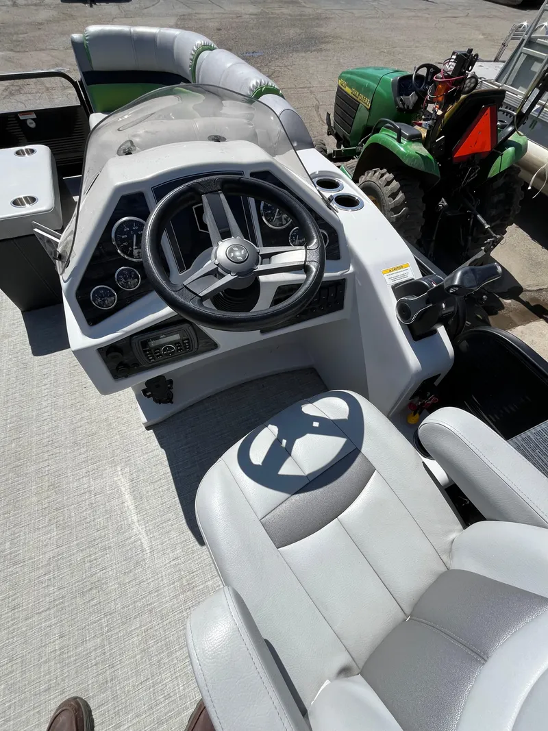 Slide: The Image of 2018 Sweetwater 2286 boat cockpit with steering wheel and seating. - 5
