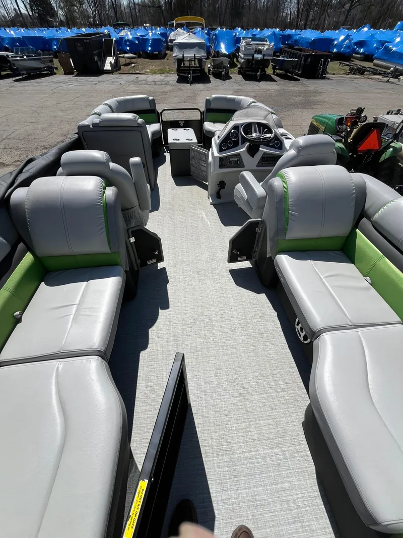 Slide: The Image of 2018 Sweetwater 2286 pontoon boat interior with gray and green seating. - 7