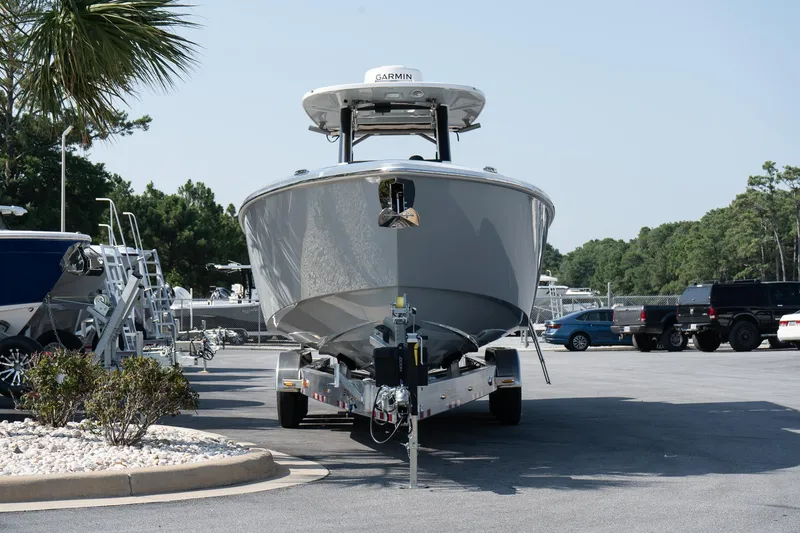 Slide: The Image of 2025 Solace 32 CS boat on trailer in parking lot. - 12