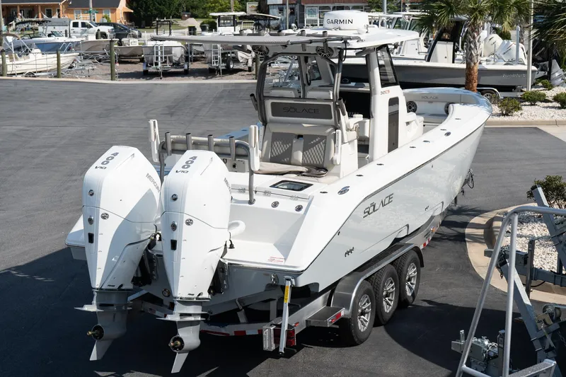 Slide: The Image of 2025 Solace 32 CS boat with dual Mercury engines on a trailer. - 16