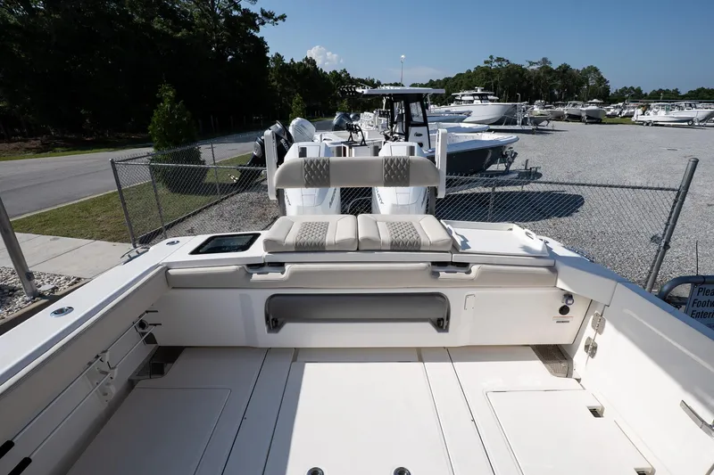 Slide: The Image of 2026 Solace 32 CS boat interior with seating, parked in a marina under clear skies. - 19