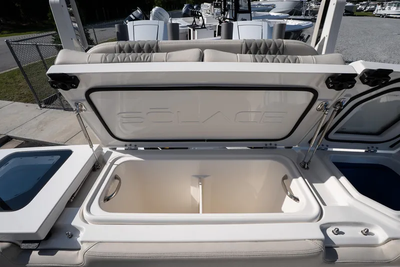 Slide: The Image of Open storage compartment on 2026 Solace 32 CS boat, showcasing spacious interior design. - 22