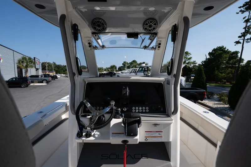 Slide: The Image of Interior view of 2026 Solace 32 CS boat cockpit with modern controls and steering wheel. - 26