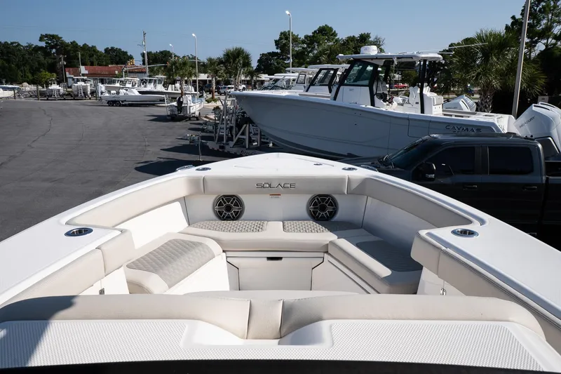 Slide: The Image of 2026 Solace 32 CS boat with spacious seating, docked in a marina. - 31