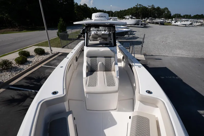 Slide: The Image of 2026 Solace 32 CS boat with sleek design and comfortable seating in a marina setting. - 35