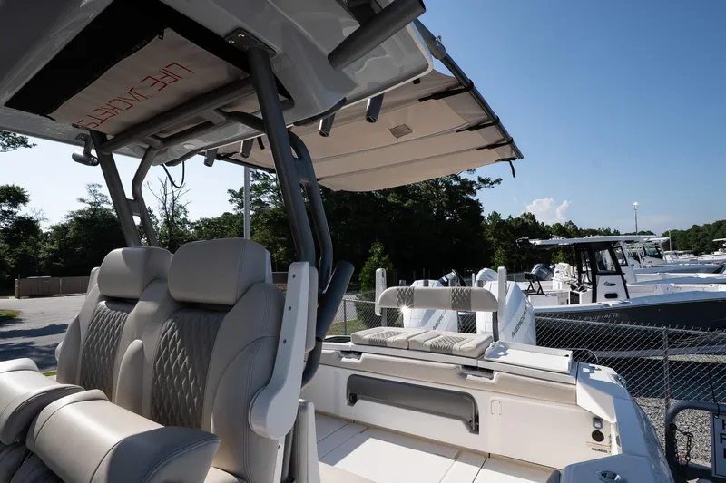 Slide: The Image of 2026 Solace 32 CS boat interior with luxurious seating and canopy, docked under clear blue sky. - 37