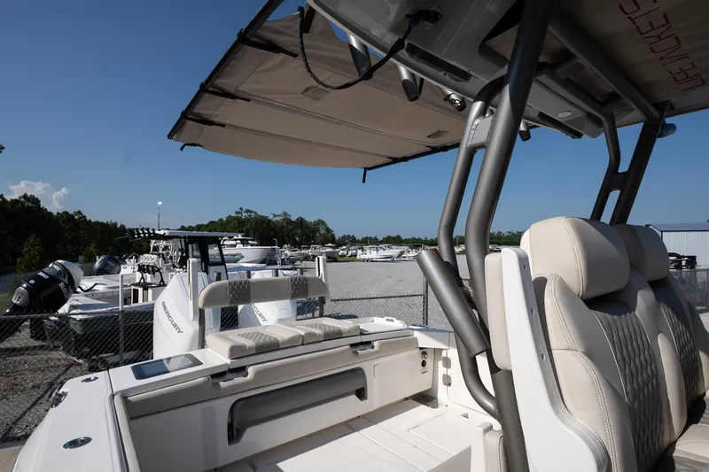 Slide: The Image of 2026 Solace 32 CS boat interior with seating and canopy, parked in a marina. - 38