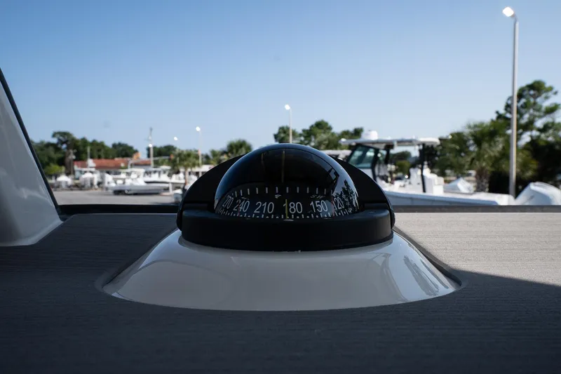 Slide: The Image of Compass on Solace 32 CS boat, 2026 model, with marina background. - 39