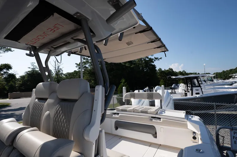 Slide: The Image of 2026 Solace 32 CS boat interior with luxury seating and canopy, docked under clear blue sky. - 41