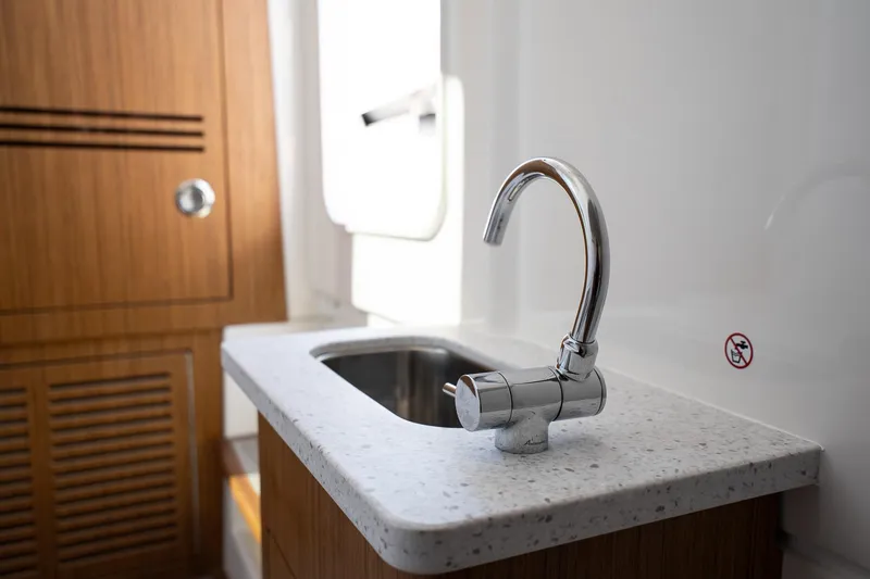 Slide: The Image of Modern boat interior with sleek faucet and countertop, Solace 32 CS, 2026 model. - 43