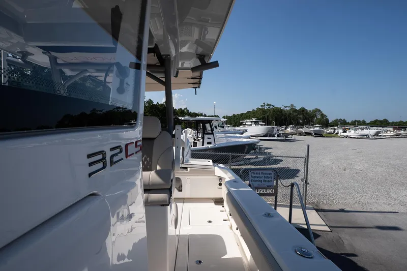 Slide: The Image of 2026 Solace 32 CS boat docked in a marina under clear blue skies. - 44