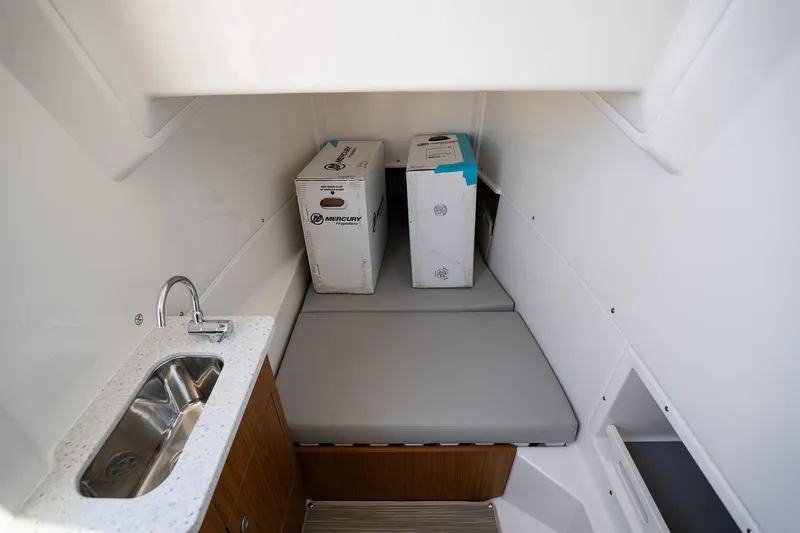 Slide: The Image of Interior of 2026 Solace 32 CS boat with sink and storage area. - 45