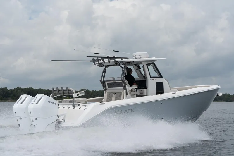 Slide: The Image of 2026 Solace 32 CS boat cruising on water with twin Mercury engines. - 8