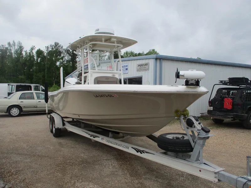 Slide: The Image of 2020 Crevalle 26 HCO boat on trailer, parked outdoors near a building. - 1