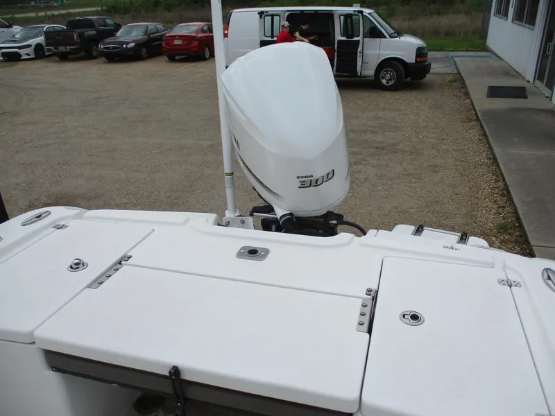 Slide: The Image of 2020 Crevalle 26 HCO boat with a powerful outboard motor in a parking area. - 11