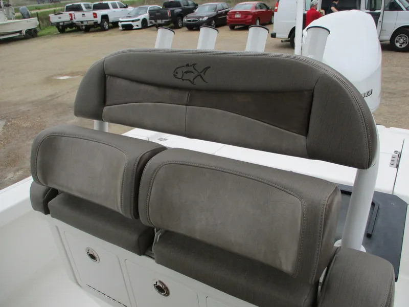 Slide: The Image of 2020 Crevalle 26 HCO boat seating with rod holders and fish emblem. - 12