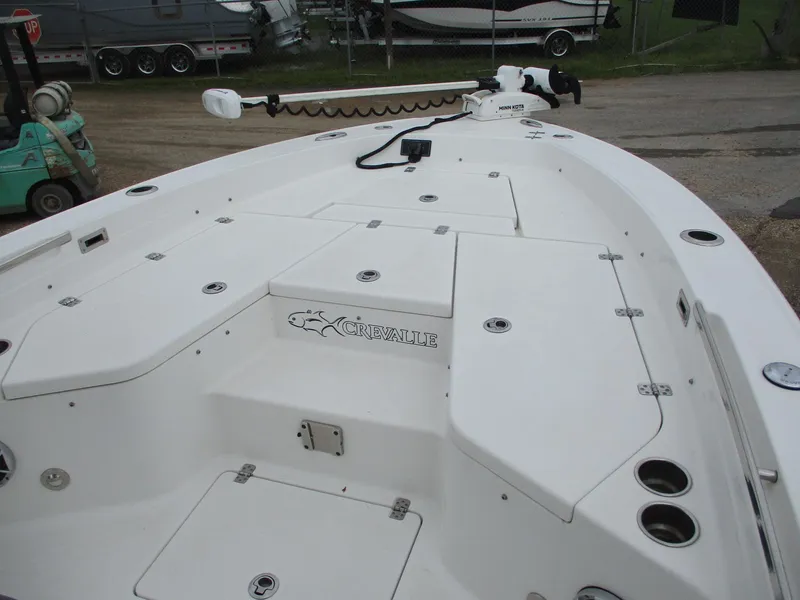 Slide: The Image of 2020 Crevalle 26 HCO boat deck with storage compartments and fishing rod holders. - 14